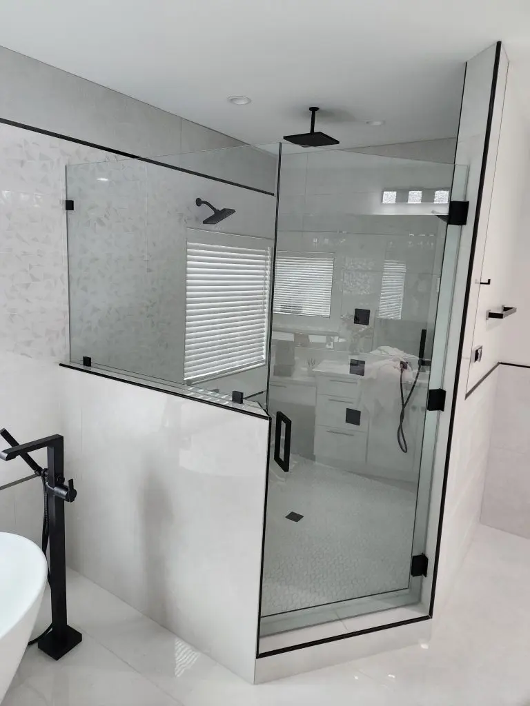 Frameless shower enclosure